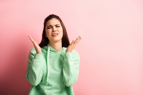 Upset girl standing with open arms asking why the need for insulation replacement