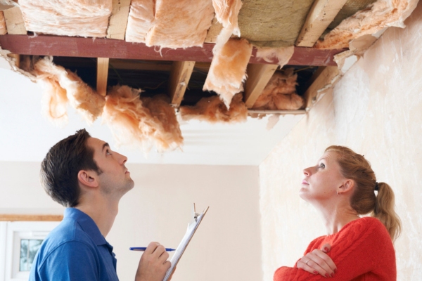 builder and client looking at damaged roof insulation depicting personal recommendations