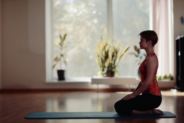 woman meditating in well insulated home gym