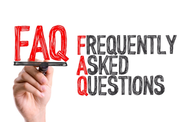 Hand with marker writing the words FAQ and frequently asked questions